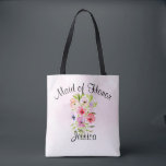 Tote Bag Bouquet de fleurs d'aquarelle Maid of Honor Mariag<br><div class="desc">Ce joli fourre-tout est le sac à bagages parfait pour remercier votre bonne d'honneur pour son travail acharné qui rend votre jour de mariage spécial. Il présente un beau bouquet d'aquarelle de fleurs sauvages, de pansies ou de violets sur un arrière - plan rose pâle. La légende en haut dit...</div>
