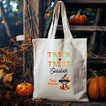 Tote Bag Chatouille chatte Casquette Trick ou traiter Hallo<br><div class="desc">Chat noir mignon dans un casquette de sorcières portant un jack-o-lanterne et assis parmi les fleurs avec encore un autre jack-o-lanterne à ses pieds "Trick ou Treat" "Happy Halloween" conception de vacances. Conception composite par Holiday Hearts Designs.</div>