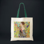 Tote Bag Lady with Fan by Gustav Klimt, Vintage Japonism<br><div class="desc">Lady with Fan (1918) by Gustav Klimt is a vintage Victorian Era Symbolism fine art portrait painting. A beautiful brunette woman holding an oriental fan. The golden floral Japanese themed background is full of blooming exotic flowers, peacocks and other birds with outstretched wings. About the artist: Gustav Klimt (1862-1918) was...</div>