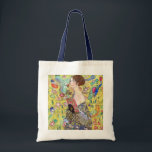 Tote Bag Lady with Fan by Gustav Klimt, Vintage Japonism<br><div class="desc">Lady with Fan (1918) by Gustav Klimt is a vintage Victorian Era Symbolism fine art portrait painting. A beautiful brunette woman holding an oriental fan. The golden floral Japanese themed background is full of blooming exotic flowers, peacocks and other birds with outstretched wings. About the artist: Gustav Klimt (1862-1918) was...</div>