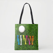 Tote Bag Les tee - shirts de golf sont sur l'herbe verte. (Devant)