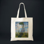 Tote Bag Monet La Promenade Femme avec Parasol<br><div class="desc">Claude Monet La Femme Promenade avec un Parasol. Peinture à l'huile sur toile de 1875. L'une des oeuvres les plus charmantes de Monet, The Promenade, présente une jeune femme et un enfant debout dans un champ au-dessus de fleurs sauvages jaunes. La femme tient un parasol vert et bleu tandis que...</div>