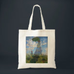 Tote Bag Monet La Promenade Femme avec Parasol<br><div class="desc">Claude Monet La Femme Promenade avec un Parasol. Peinture à l'huile sur toile de 1875. L'une des oeuvres les plus charmantes de Monet, The Promenade, présente une jeune femme et un enfant debout dans un champ au-dessus de fleurs sauvages jaunes. La femme tient un parasol vert et bleu tandis que...</div>