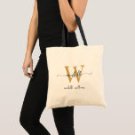 Tote Bag Monogramme noir élégant Nom Girly Script<br><div class="desc">Girly Stylish Modern Black and Gold Monogramme Nom initial Signature Script Custom Boutique personnalisée Sac fourre-tout budgétaire. Ce design avec un prénom dans un joli style lettré à la main typographie (ou calligraphie) avec monogramme initial et nom de famille ou nom complet en noir et or sur crème naturelle blanc....</div>
