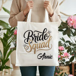 Tote Bag Personalized Gold Bride Squad Bachelorette Party<br><div class="desc">Get ready for the ultimate girls' getaway with this chic Bride Squad tote bag! Featuring elegant gold-toned typography and sparkling diamond accents, this bag is the perfect accessory for bachelorette weekends, bridal showers, or as a stylish wedding welcome bag. Durable and spacious, it's designed to hold all your party essentials...</div>