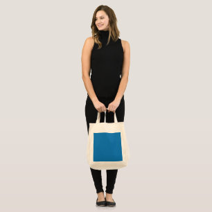 Tote Bag un arrière - plan bleu avec une horloge noire et b