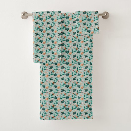 Towels with a teal floral pattern hang 