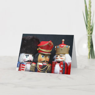 Trois noix de cou sur la carte noire de Noël