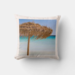 Tropisch strand met rieten parasol kussen