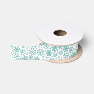 Turquoise sneeuwvlokken op wit lint