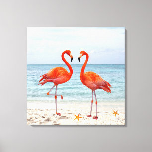 Twee levendige roze flamingo's op het strand Canva Canvas Afdruk