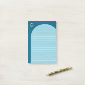 Twee tinten blauw gevoerd boog monogram post-it® notes (Op bureau)