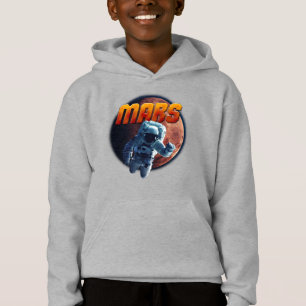 Un astronaute devant la planète Mars.