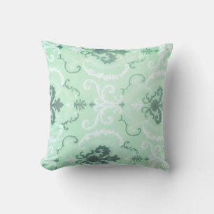 Un coussin décoratif vert pastel doux