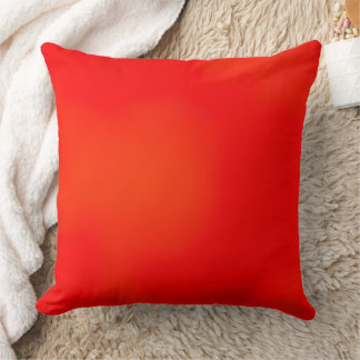 Un oreiller carré avec un rouge et un orange vibra