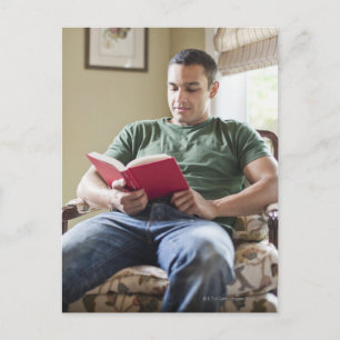 US, Utah, Young man reading Book Briefkaart