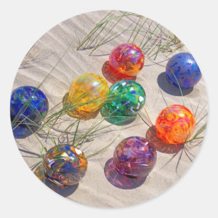 USA, Oregon. Colorful Glass Floats On Sand Dune Ronde Sticker