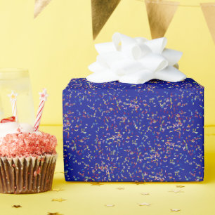 Verjaardagstaart strooit op blauw cadeaupapier