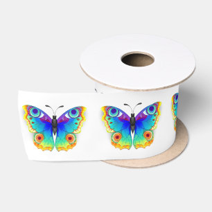 Vlinder met pauwenogen in regenboogkleuren lint