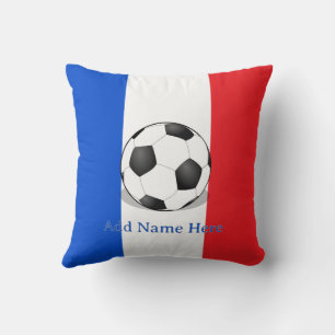 Voetbal op rode, witte en blauwe achtergrond kussen