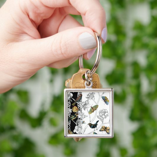 Vogels en vlinder op een zwarte en witte achtergro sleutelhanger (Hand)