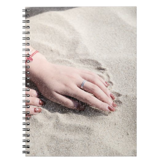 Vrouw die op wit zand ligt notitieboek (Voorkant)