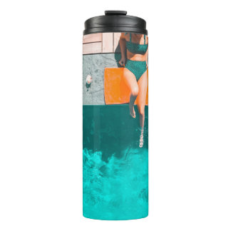 Vrouw die 's ochtends naast het zwembad ligt thermosbeker