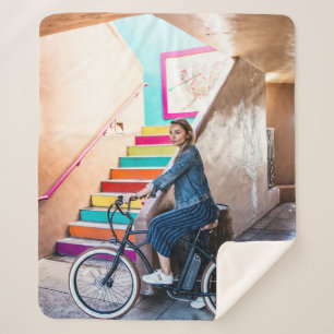 Vrouw met een blauwe denim-jas en een korte pit sherpa deken