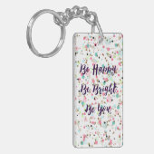 "Wees blij. Wees helder. Ben jij." Ik citeer stip Sleutelhanger (Voorkant Links)