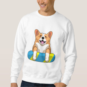 Welsh Corgi tijdens het zwemmen met een zwembord Trui