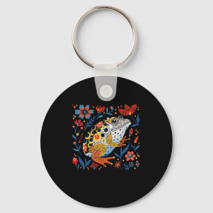 Whimsical geïllustreerde kikker met levendige bloe sleutelhanger