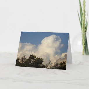 White Puffy Clouds over Treetops Background Kaart