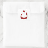 White sticker with red noun logo (Tas)