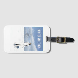 Winter Greetings. Female elf walking in the snow Bagagelabel