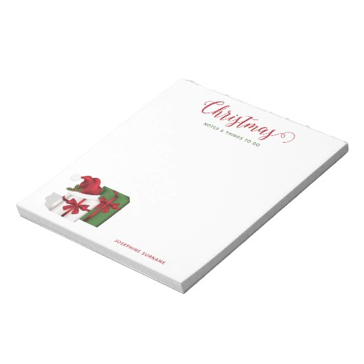 Witte en groene wasdozen met een kersthat notitieblok (Gedraaid)