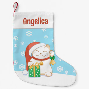 Witte kerstkat in een rood Pet Kleine Kerstsok