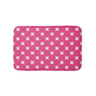 Witte kruisstiften op fuchsia badmat