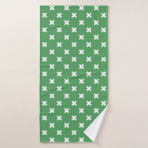 Witte kruisstiften op groen badhanddoek