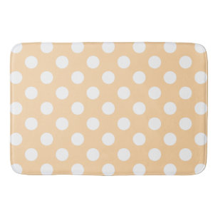 Witte polka-stippen op beige badmat