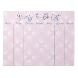 Witte schelpen op lichtroze wekelijkse to-do lijst notitieblok