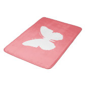 Witte vlinder op koraalroze badmat (Gekanteld)