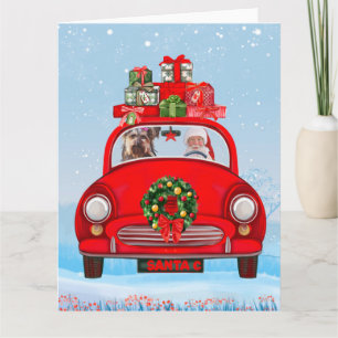 Yorkshire Terrier-hond in auto met kerstman Kaart