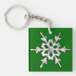 Zilver en witte sneeuwvlok op pijngroen sleutelhanger