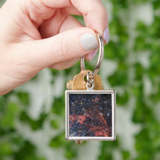 Zoeken naar overlevende van een supernova-explosie sleutelhanger (Hand)