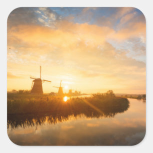Zonneopstand boven windmolens en een rivier in Ned Vierkante Sticker