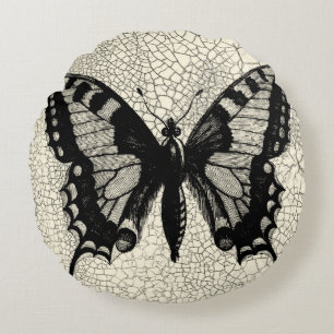 Zwart-witte vlinder op gekraakte achtergrond rond kussen