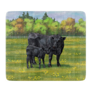 Zwarte Angus-Koe en Cute Calf in zomerperiode Snijplank