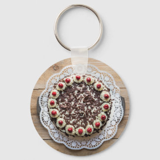 Zwarte boswatta op rustic hout sleutelhanger