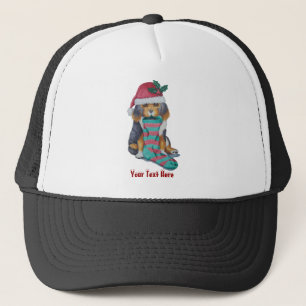 zwarte en bruine puppy met kerstmis trucker pet