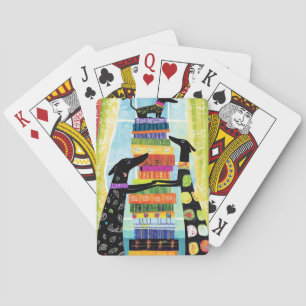 Zwarte honden die een toren van boeken in evenwich pokerkaarten